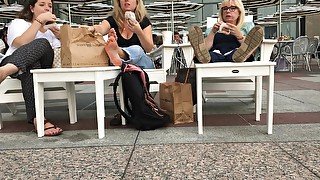 Three Female Strangers Reveal Their Feet While Eating At The Restaurant Outdoors