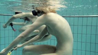 Girls swimming underwater and enjoying eachother