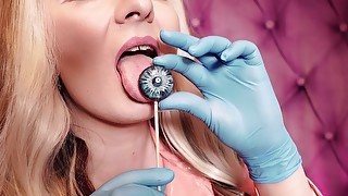 ASMR: blue nitrile gloves and candy sucking, wearing pink PVC coat, girl in braces (Arya Grander)