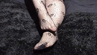 Close up of Wolf's cute feet in skull fishnets for your foot fetish pleasure