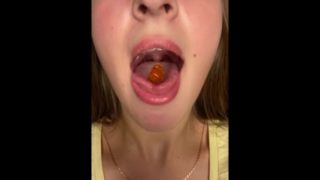 Swallowing gummy bears with open mouth