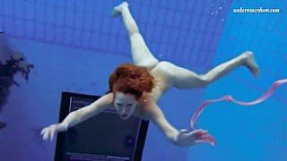 Curly hair redhead swims and looks sexy