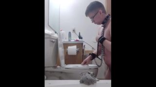 chained slave cleans toilet