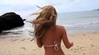 Dionne Daniels strips on the beach