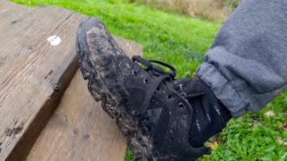 Russian guy smokes a cigarette in dirty shoes and spits