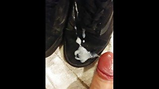 Big dick unloads white cum on black Vans shoes after fucking them