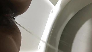 Girl pisses in the toilet at a gas station and shows a pad