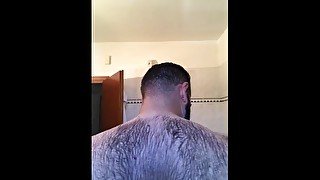 Italian bear in the shower washes his hairy body