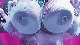 Hot chick washing her boobs in a foamy shower