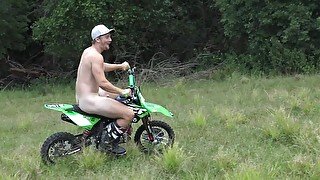 Naked man riding a Dirt bike