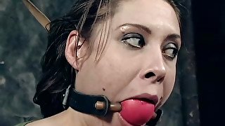 Laura gets her mouth and cunt fucked with a dildo in BDSM clip