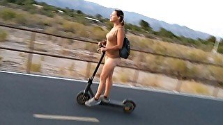 Real amateur milf rides scooter naked on bike path