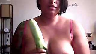 Thick and busty brunette strumpet on webcam plays with a cucumber