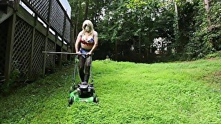 Big fake tits halter top Daisy Dukes wearing crossdresser cutting the grass