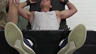 Restrained young dude has his dashing body and feet tickled