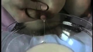 Big breasted amateur lady milks her nipples and fills a bowl