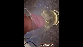 Desperately pissing in secret into a pint glass