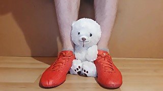 Teen torturing and trampling teddy bear with Adidas football shoes