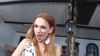 A redheaded shemale pumps her thick cock until she cums