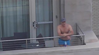 Sexy guy at the hotel balcony