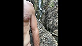 Hairy Muscular Guy Pissing at a Public Waterfall