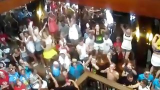 German girls dance in bikini on tables in a bar and flash their tits