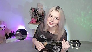 Hot blonde girl playing on ukulele and singing in naughty outfit