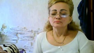 Naughty mature woman with glasses flashes her big tits on t