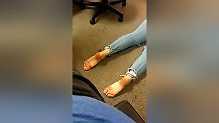 Dark Haired Woman In Blue Jeans Poses Barefoot On The Floor