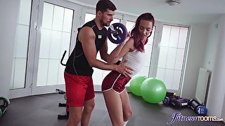 Redhead model undressed and fucked by her personal trainer