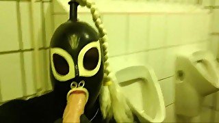 Rubberdoll Monique - Blowjob training in a public toilet