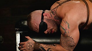 Submissive man is tied and used by a tattooed domina