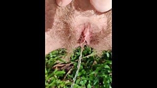 Amazing outdoor hairy pussy pissing filmed close up in slow motion