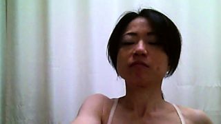 Asian chick unwittingly exposes her small tits to a hidden