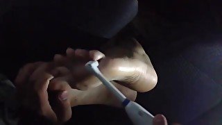 Guy tickles his girlfriends feet in car