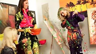 Clothed women make a mess with paint