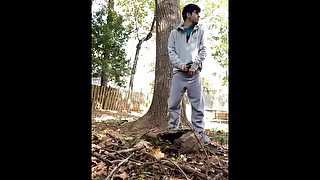 jerking off behind a tree in his backyard