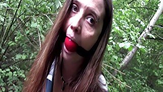 Walking cuffed and gagged outdoors