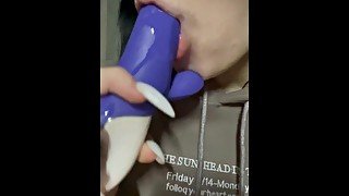 A girl sucks on a vibrator