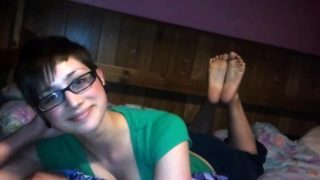 Pretty brunette teen with glasses shows off her sexy feet