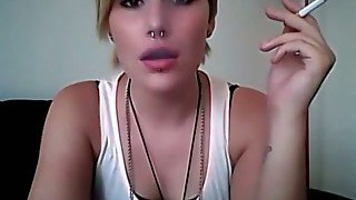 This punk bitch knows how to smoker seductively on camera