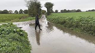 Muddy fields, rain suit in the rain