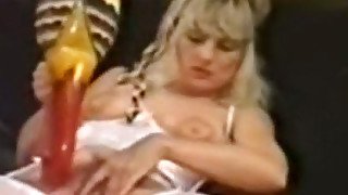 Busty and lascivious blonde milf in white lingerie masturbates on the couch