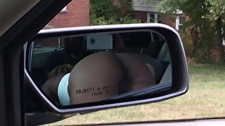 Black slut sucking dick in car. View of ass.