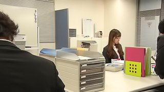 Horny chick Anri Hoshizaki masturbates on a big office desk