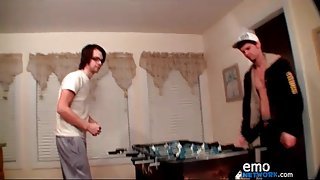 Guys strip as they play foosball