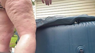 Sexy milf gets caught playing in the hot tub