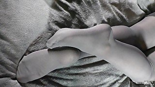 Foot fetish legs in grey opaque tights