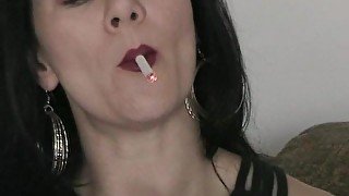 Solo brunette smoking while masturbating using a toy in closeup shoot