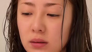 Minori Hatsune fingers her hairy Japanese pussy in the shower